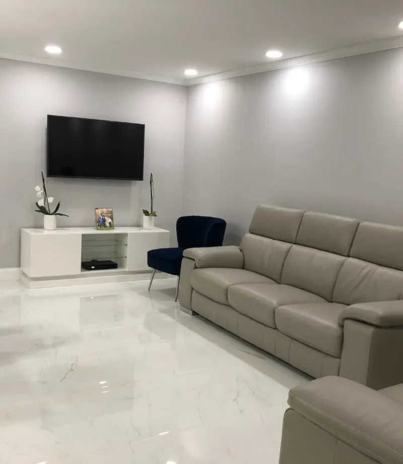 Hallway with two-tone paint, chair rail molding and wood-look accent wall — interior painting by South Blue Enterprises in South Florida