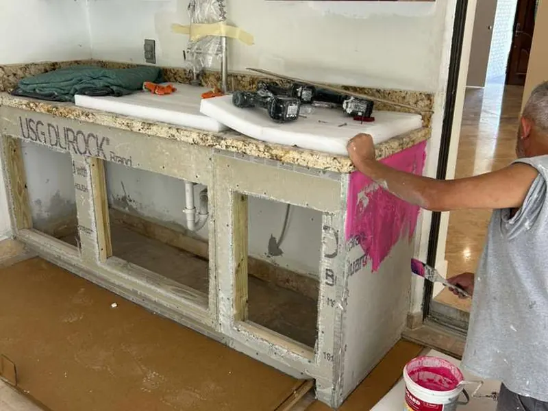 Cement board substrate prep with cabinet integration in progress — drywall and plaster repair by South Blue Enterprises in Deerfield Beach, FL
